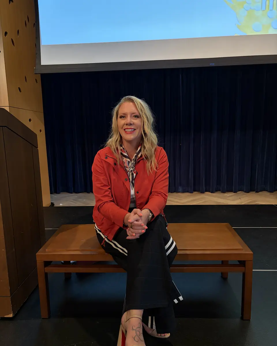 Ashlei seated on the edge of the stage during Q and A